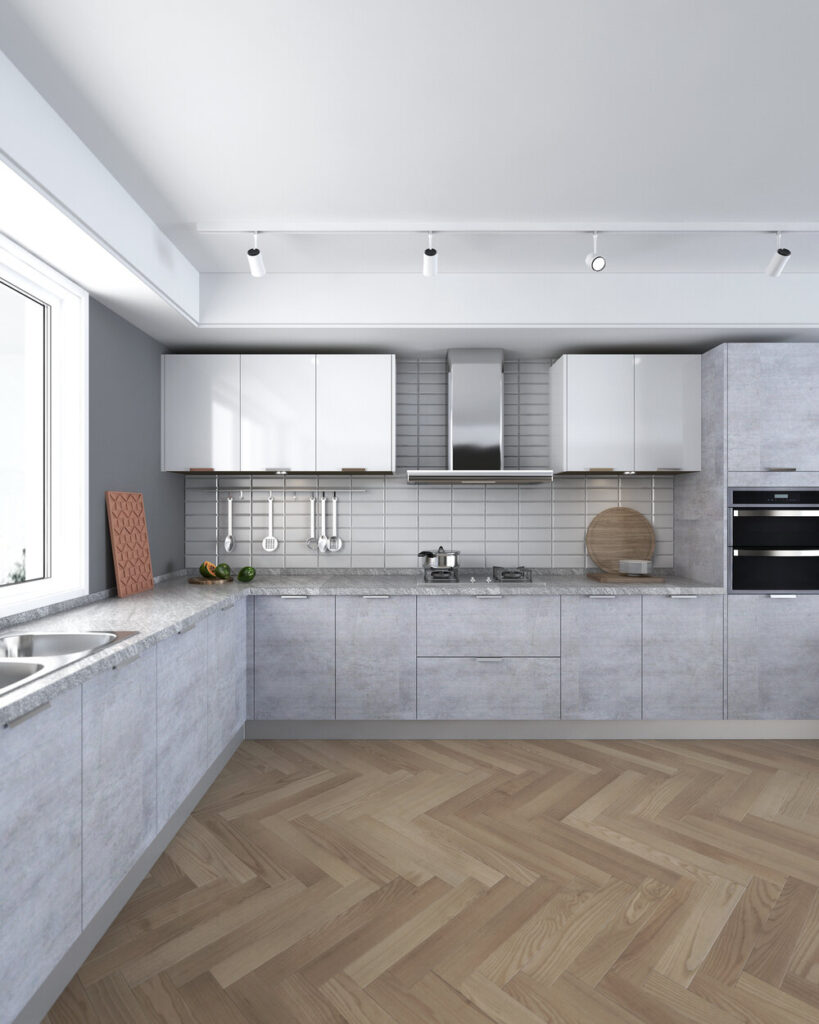 Laminate màu cement xám, dạng chữ L, thiết kế không tay nắm – hiện đại tối giản.